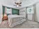 Cozy bedroom with a ceiling fan, two windows, and carpeted floors at 543 S Holly Springs Rd, Woodstock, GA 30188