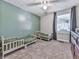 ' room with two twin beds, green accent wall, and carpeted floors at 543 S Holly Springs Rd, Woodstock, GA 30188