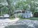 Exterior view of home featuring detached garage, screened in porch, and mature trees at 543 S Holly Springs Rd, Woodstock, GA 30188