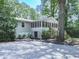 Exterior view of a home featuring a screened porch with stairs and mature trees on the property at 543 S Holly Springs Rd, Woodstock, GA 30188