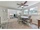 The living room has neutral paint, a ceiling fan, and overlooks the dining area at 543 S Holly Springs Rd, Woodstock, GA 30188