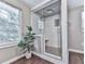 Modern glass-enclosed shower with rain shower head, seat, and niche storage at 543 S Holly Springs Rd, Woodstock, GA 30188