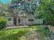 Lush backyard featuring a patio area and ample green space, ideal for outdoor relaxation and entertaining at 6385 Highway 92, Fairburn, GA 30213