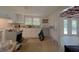 Bright kitchen featuring white cabinets and a vintage stove, ready for renovation and personalization at 6385 Highway 92, Fairburn, GA 30213