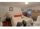 Cozy bedroom with a brick fireplace, a comfortable bed, and natural light filtering through the window at 6385 Highway 92, Fairburn, GA 30213