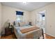 Comfortable bedroom with a bed, wood floors, a window and an attached bathroom at 954 Bryant Sw St, Conyers, GA 30012