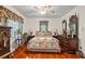 Comfortable bedroom with hardwood floors, a floral bedding ensemble, and matching nightstands at 954 Bryant Sw St, Conyers, GA 30012