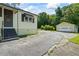 Side view of a one-story home with a detached garage and a cracked driveway at 954 Bryant Sw St, Conyers, GA 30012