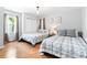 Bright bedroom featuring two beds with matching quilts, hardwood floors, and natural light at 1359 Scott Blvd, Decatur, GA 30030