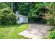 Detached garage with a driveway surrounded by lush greenery and mature trees at 1359 Scott Blvd, Decatur, GA 30030
