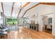 Open-concept living room with vaulted ceiling, wood beams, hardwood floors, and seamless flow to the kitchen at 1359 Scott Blvd, Decatur, GA 30030