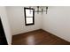 Clean bedroom with dark hardwood floors and bright light from one window at 1658 Altadena Sw Pl, Atlanta, GA 30311