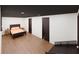 This bedroom features warm wood flooring, a dark colored ceiling, and a king-sized bed at 1658 Altadena Sw Pl, Atlanta, GA 30311