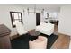 Elegant living room with white furnishings, dark rug, and eat-in kitchen nearby at 1658 Altadena Sw Pl, Atlanta, GA 30311