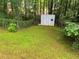 Backyard view, showing a storage shed, lush greenery, and chain link fence at 185 Colemans Bluff Dr, Woodstock, GA 30188