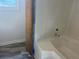 Clean bathroom with a sleek, modern tub and shower with neutral colored walls and flooring at 185 Colemans Bluff Dr, Woodstock, GA 30188
