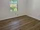Bedroom boasts modern flooring, ample natural light from the window, and fresh white walls at 185 Colemans Bluff Dr, Woodstock, GA 30188