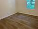 Cozy bedroom showcasing new floors, fresh paint, and a bright window allowing natural light at 185 Colemans Bluff Dr, Woodstock, GA 30188
