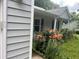 Up close view of a home's exterior, showcasing flower garden and blue shutters at 185 Colemans Bluff Dr, Woodstock, GA 30188