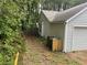 Side view of the house, illustrating yard access around the garage and storage at 185 Colemans Bluff Dr, Woodstock, GA 30188