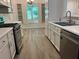 Stylish kitchen with stainless steel appliances, refinished cabinets and fixtures and an eat-in area at 185 Colemans Bluff Dr, Woodstock, GA 30188