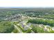 Aerial view showcasing a neighborhood with lush trees and well maintained lawns at 1865 Henley Way, Alpharetta, GA 30009