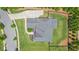 Aerial view of home showing landscaping, roof, driveway, and surrounding lawn at 1865 Henley Way, Alpharetta, GA 30009