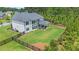 Aerial view of the rear of the house showing the covered patio, fenced yard, and lush landscaping at 1865 Henley Way, Alpharetta, GA 30009