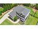 Aerial view of home showing driveway, landscaping, basketball hoop, and well manicured lawn at 1865 Henley Way, Alpharetta, GA 30009