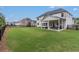 Spacious backyard with a covered patio and black fencing, great for outdoor activities at 1865 Henley Way, Alpharetta, GA 30009