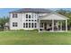 Spacious backyard featuring a covered patio with outdoor seating, and a well-maintained lawn at 1865 Henley Way, Alpharetta, GA 30009