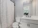 Modern bathroom featuring a single vanity and shower with patterned curtain at 1865 Henley Way, Alpharetta, GA 30009