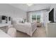 Bright bedroom with a large window, natural light, and plush furniture at 1865 Henley Way, Alpharetta, GA 30009