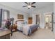 Comfortable bedroom with a ceiling fan and attached bathroom access at 1865 Henley Way, Alpharetta, GA 30009