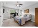 Well-lit bedroom with space for a work area and neutral carpet at 1865 Henley Way, Alpharetta, GA 30009