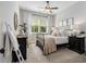 Stylish bedroom features a comfortable bed, accent ladder, and natural light from the window at 1865 Henley Way, Alpharetta, GA 30009