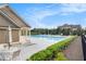Community pool area featuring lounge chairs, tables, and a nearby clubhouse at 1865 Henley Way, Alpharetta, GA 30009