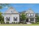 Charming two-story brick home featuring gray shutters, a manicured lawn, and a welcoming front porch at 1865 Henley Way, Alpharetta, GA 30009