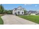 Exterior view of home showing driveway, 3 car garage, landscaping, and basketball hoop at 1865 Henley Way, Alpharetta, GA 30009