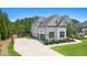 View of the home highlighting its spacious driveway and manicured landscaping at 1865 Henley Way, Alpharetta, GA 30009