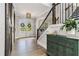 Elegant foyer featuring wood floors, a staircase with iron railings, and a decorative cabinet at 1865 Henley Way, Alpharetta, GA 30009