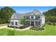 Beautiful two-story home with a lush green lawn, basketball hoop, and a charming front porch at 1865 Henley Way, Alpharetta, GA 30009