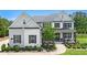 Stunning two-story home with a manicured lawn, landscaping, and inviting front porch at 1865 Henley Way, Alpharetta, GA 30009