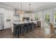 Open concept kitchen with stainless appliances, a center island with seating, and stylish pendant lighting at 1865 Henley Way, Alpharetta, GA 30009