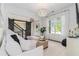 Cozy living room with shiplap walls, a decorative chandelier, and comfortable seating at 1865 Henley Way, Alpharetta, GA 30009