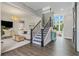 Open-concept living space with a staircase, wood floors, and bright, airy atmosphere at 1865 Henley Way, Alpharetta, GA 30009