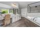 Bright bathroom with an oversized soaking tub, glass enclosed shower, and vanity at 1865 Henley Way, Alpharetta, GA 30009