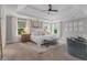 Spacious main bedroom features tray ceilings, two windows, sitting area, and neutral color scheme at 1865 Henley Way, Alpharetta, GA 30009