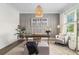 Stylish home office with paneled walls, a modern desk, and a cozy armchair at 1865 Henley Way, Alpharetta, GA 30009