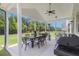 Covered outdoor patio with a dining area and barbecue for entertaining guests at 1865 Henley Way, Alpharetta, GA 30009